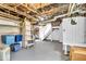 Unfinished basement featuring painted floor, exposed ducts and pipes, a shelving unit with bins and a ladder at 625 Sanders St, Indianapolis, IN 46203