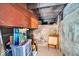 Unfinished basement with storage, a concrete wall, wood beams, and limited headroom at 625 Sanders St, Indianapolis, IN 46203