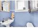 Charming powder room with pedestal sink and vintage-inspired fixtures at 625 Sanders St, Indianapolis, IN 46203