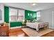 Bedroom features light green walls, a soft rug, and a gold bed frame at 625 Sanders St, Indianapolis, IN 46203