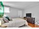 Bedroom featuring hardwood floors, a soft rug, and a gray accent wall at 625 Sanders St, Indianapolis, IN 46203