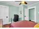 Bedroom with light green walls also features a desk area at 625 Sanders St, Indianapolis, IN 46203