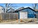 Detached one car garage with a white garage door and blue painted siding, viewed from the backyard at 625 Sanders St, Indianapolis, IN 46203