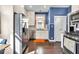 Modern kitchen with stainless steel appliances and a bright blue accent wall at 625 Sanders St, Indianapolis, IN 46203
