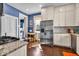 Eat-in kitchen featuring white cabinets, stainless steel appliances, and stylish hardwood floors at 625 Sanders St, Indianapolis, IN 46203