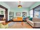 Bright living room features hardwood floors, large windows, and vintage fixtures at 625 Sanders St, Indianapolis, IN 46203