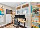 Bright home office with a standing desk, hardwood floors, and custom shelving at 625 Sanders St, Indianapolis, IN 46203