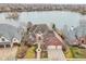 Stunning lakefront property featuring a brick home, beautiful landscaping, and a spacious two-car garage at 6437 N Oxbow Way, Indianapolis, IN 46220