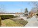 Manicured backyard featuring a stone patio, gazebo, and lake at 6437 N Oxbow Way, Indianapolis, IN 46220