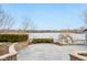 Beautiful outdoor terrace with stonework and a lake view at 6437 N Oxbow Way, Indianapolis, IN 46220