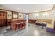 Entertainment space with a built-in bar, seating, and wood paneling at 6437 N Oxbow Way, Indianapolis, IN 46220
