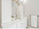 Bright bathroom with a white vanity, mirror, and bronze fixtures at 6437 N Oxbow Way, Indianapolis, IN 46220