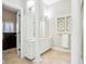 Bright bathroom featuring a white vanity, decorative window, and neutral tile flooring at 6437 N Oxbow Way, Indianapolis, IN 46220