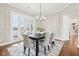 Inviting dining room with paneled walls, lake views, and a modern chandelier for sophisticated gatherings at 6437 N Oxbow Way, Indianapolis, IN 46220