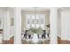 Bright dining room with a chandelier, white trim, and views to the outdoors for elegant entertaining at 6437 N Oxbow Way, Indianapolis, IN 46220