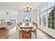 Sun-lit dining room with large windows, hardwood floors, and a chandelier at 6437 N Oxbow Way, Indianapolis, IN 46220