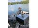Outdoor dock space with a small table and outdoor seating overlooking the lake, providing a beautiful view at 6437 N Oxbow Way, Indianapolis, IN 46220