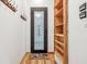Entryway with a decorative front door, wooden shelves, and a coat rack at 6437 N Oxbow Way, Indianapolis, IN 46220