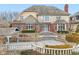 Rear exterior view of the home with a stone terrace and landscaping at 6437 N Oxbow Way, Indianapolis, IN 46220