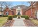 Beautiful brick two-story home featuring a walkway leading to a grand entrance and manicured landscaping at 6437 N Oxbow Way, Indianapolis, IN 46220