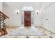 Elegant foyer featuring a decorative front door and a neutral rug with a detailed tile border at 6437 N Oxbow Way, Indianapolis, IN 46220
