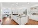 Open concept layout between the kitchen, dining, and living areas, with hardwood floors throughout at 6437 N Oxbow Way, Indianapolis, IN 46220