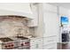 Gourmet kitchen with stainless steel appliances and a designer range hood at 6437 N Oxbow Way, Indianapolis, IN 46220