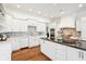 Spacious kitchen with stainless appliances, center island with countertop seating, and bright white cabinetry at 6437 N Oxbow Way, Indianapolis, IN 46220