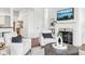 Bright living room features a fireplace, white furniture, and hardwood floors at 6437 N Oxbow Way, Indianapolis, IN 46220