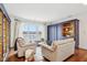 Open-concept living room with hardwood floors, a lake view, and a built-in bookcase at 6437 N Oxbow Way, Indianapolis, IN 46220