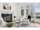 Cozy living room with a fireplace, comfortable seating, and natural light at 6437 N Oxbow Way, Indianapolis, IN 46220