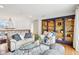 Bright living room with a stylish bookcase, a large sofa, and beautiful hardwood floors at 6437 N Oxbow Way, Indianapolis, IN 46220