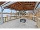 Covered outdoor patio has a fireplace and stone flooring with views of the lake at 6437 N Oxbow Way, Indianapolis, IN 46220