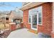 Outdoor patio features built in grill, stone patio, and door with Home Sweet Home welcome mat at 6437 N Oxbow Way, Indianapolis, IN 46220