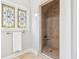 Walk-in shower with glass door, mosaic tile, and a stained-glass window at 6437 N Oxbow Way, Indianapolis, IN 46220