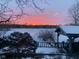 Picturesque lake view at sunset over a snow-covered lake with a gazebo and beautiful sky at 6437 N Oxbow Way, Indianapolis, IN 46220