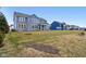 Expansive backyard view of a well-maintained lawn, showcasing the home's blue exterior and outdoor living space at 6777 Pulaski Ct, Carmel, IN 46033