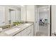 Double sink vanity with modern fixtures and view to an adjacent bedroom at 6777 Pulaski Ct, Carmel, IN 46033