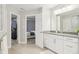 Bright bathroom with a white vanity, framed mirror, and open doorway to the bedroom at 6777 Pulaski Ct, Carmel, IN 46033