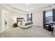 Spacious bedroom featuring a tray ceiling, soft carpet, and modern furnishings at 6777 Pulaski Ct, Carmel, IN 46033