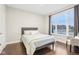 Sunlit bedroom featuring hardwood floors, a large window, and calming neutral tones at 6777 Pulaski Ct, Carmel, IN 46033