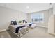 Bright bedroom featuring two twin beds, large window and neutral decor at 6777 Pulaski Ct, Carmel, IN 46033