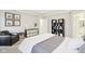 Bright bedroom showcasing a decorative shelf, dresser, and stylish black-and-white accents at 6777 Pulaski Ct, Carmel, IN 46033