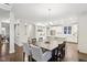Open dining area shows access to kitchen, island seating and abundant natural light at 6777 Pulaski Ct, Carmel, IN 46033