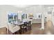 Spacious dining area with hardwood floors, large windows, and an open floor plan at 6777 Pulaski Ct, Carmel, IN 46033
