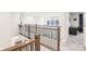 Upstairs hallway with wood and wrought iron railing overlooking the first floor and featuring a desk area at 6777 Pulaski Ct, Carmel, IN 46033
