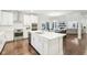 Open kitchen featuring white cabinetry, stainless steel appliances, and a kitchen island with a sink at 6777 Pulaski Ct, Carmel, IN 46033