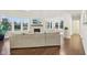 Open living room featuring a fireplace, large windows and dark hardwood floors at 6777 Pulaski Ct, Carmel, IN 46033