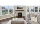Comfortable living room featuring a fireplace, large windows and dark hardwood floors at 6777 Pulaski Ct, Carmel, IN 46033