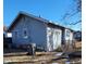 Rear view of a light blue bungalow with a small yard and alley at 710 N Drexel Ave, Indianapolis, IN 46201